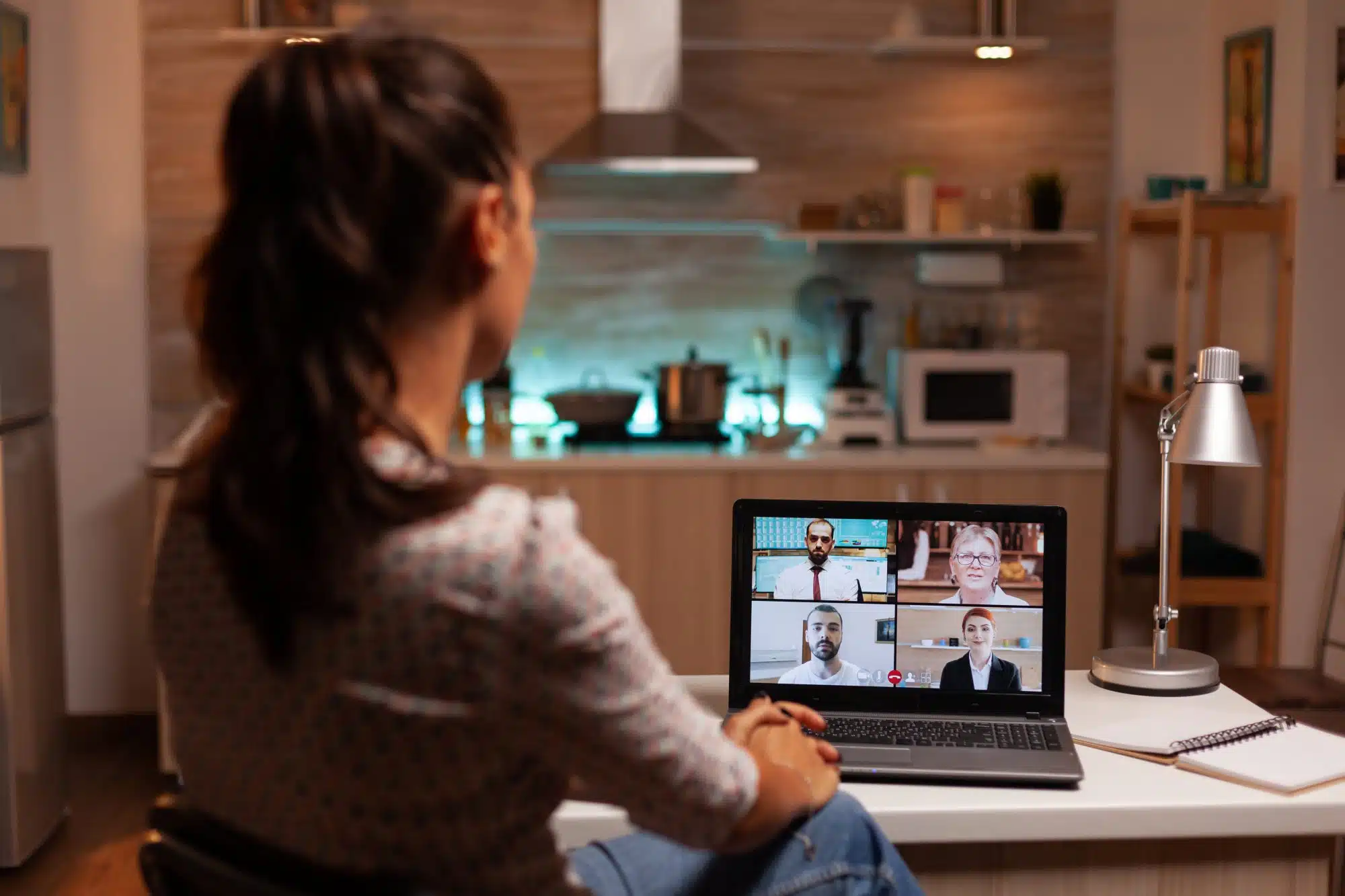 How The Johnny Makes Remote Work Easier - businesswoman having a video conference with clients midnight from home.