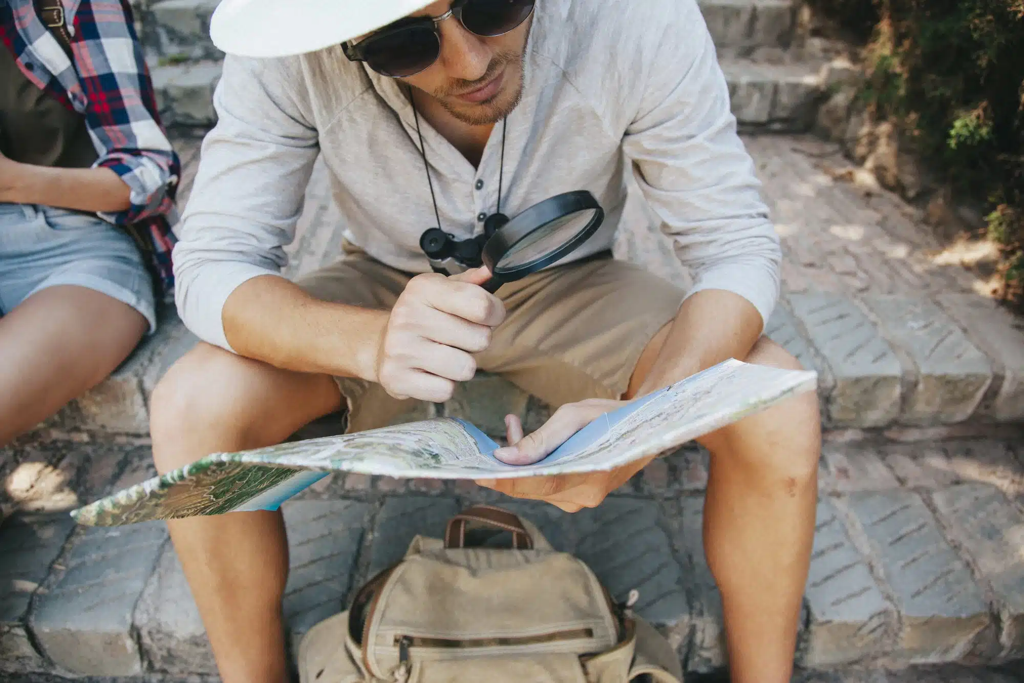 3 Local Spots Near The Johnny Worth Exploring This Weekend - Young traveler with map and loupe.